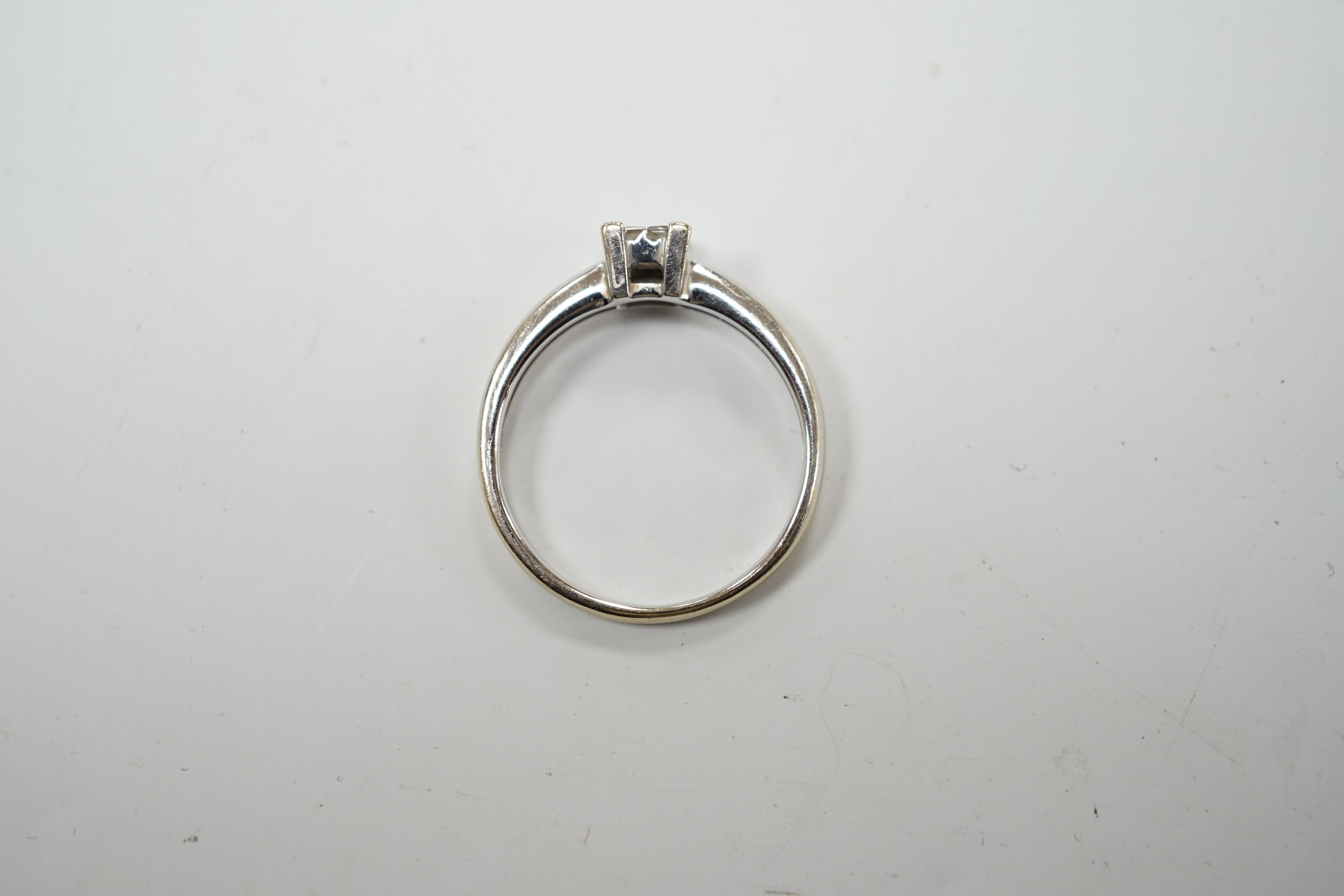 A modern 18ct white gold and four stone diamond set square cluster ring, size P/Q, gross weight 3.2 grams.